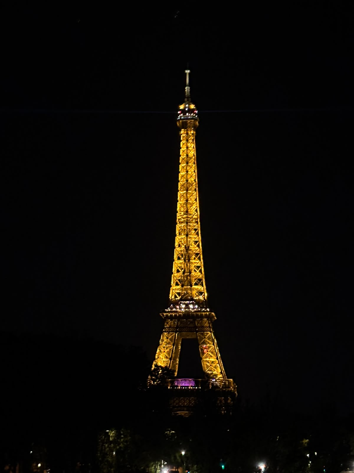 A Torre Eiffel iluminada à noite.